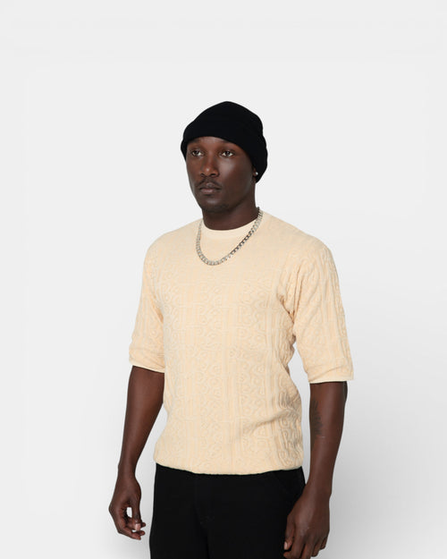 Pransh The Jacq-ed Tee in Beige, men’s 3D jacquard knit cotton premium t-shirt with all-over logo texture, relaxed boxy fit, side view
