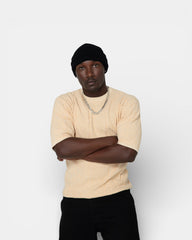 Pransh The Jacq-ed Tee in Beige premium men’s 3D jacquard knit 100% cotton t-shirt, all-over Pransh logo texture, front view on model