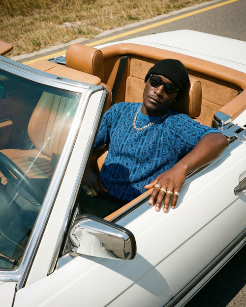 Pransh signature 3d knit 100% premium cotton Tee Collection, model in blue jacquard tee styled in a convertible car