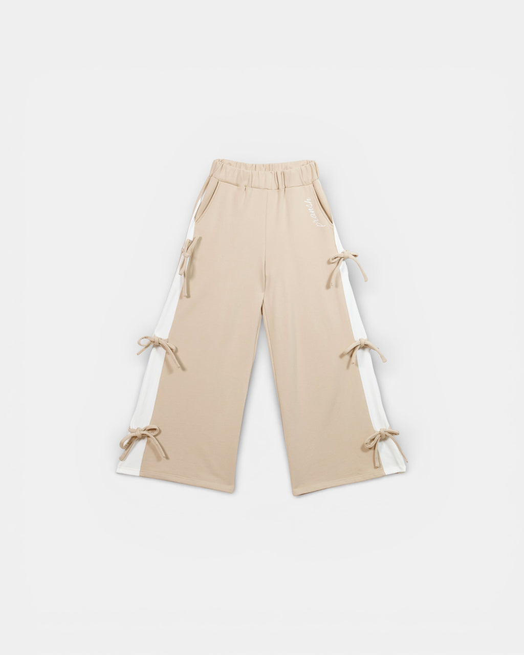 Beige pants with tie details, and side panels on a white background