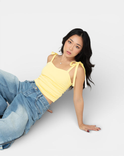 Pransh Muse Cinch Top in Honey Yellow, close-up on model showing sweetheart neckline, tie straps, and side cinch detail